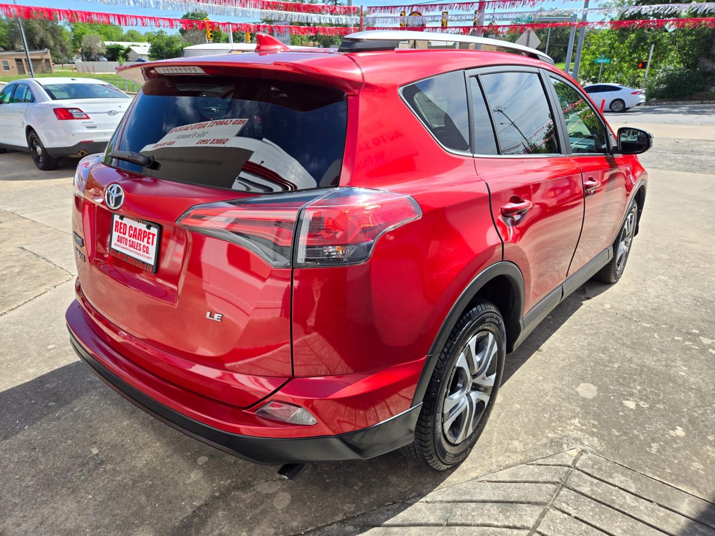 2017 Red Toyota RAV4 LE FWD (2T3ZFREV9HW) with an 2.5L L4 DOHC 16V engine, 6A transmission, located at 503 West Court, Seguin, TX, 78155, (830) 379-3373, 29.568621, -97.969803 - Photo#2